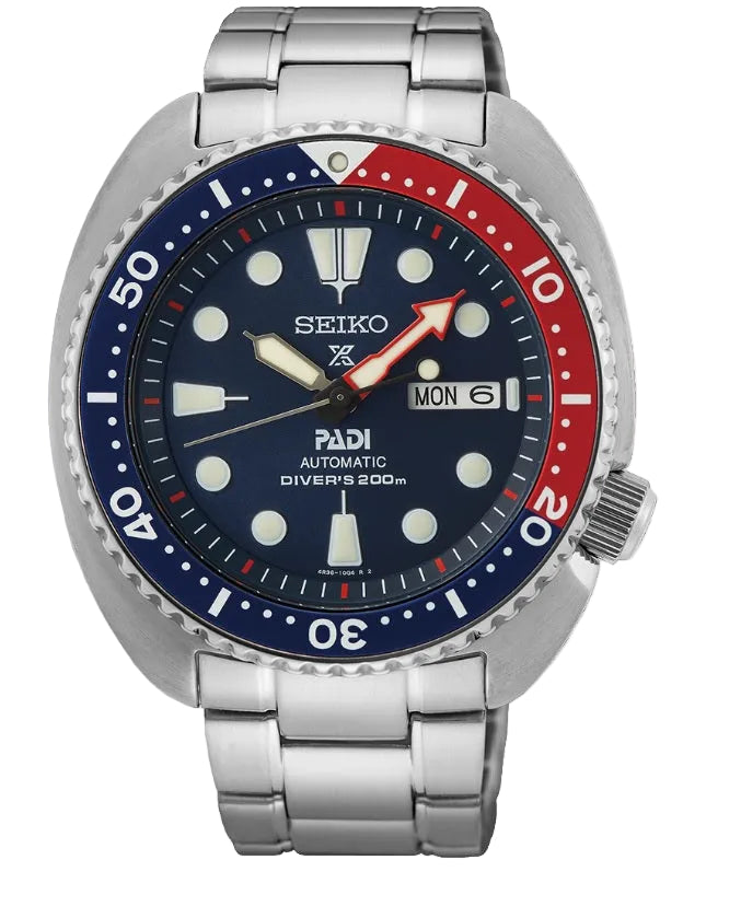 A Seiko Padi Automatic Diver's 200m watch with a stainless steel link bracelet, featuring a dark blue dial, a red and blue ceramic bezel, and silver-tone case and bracelet.